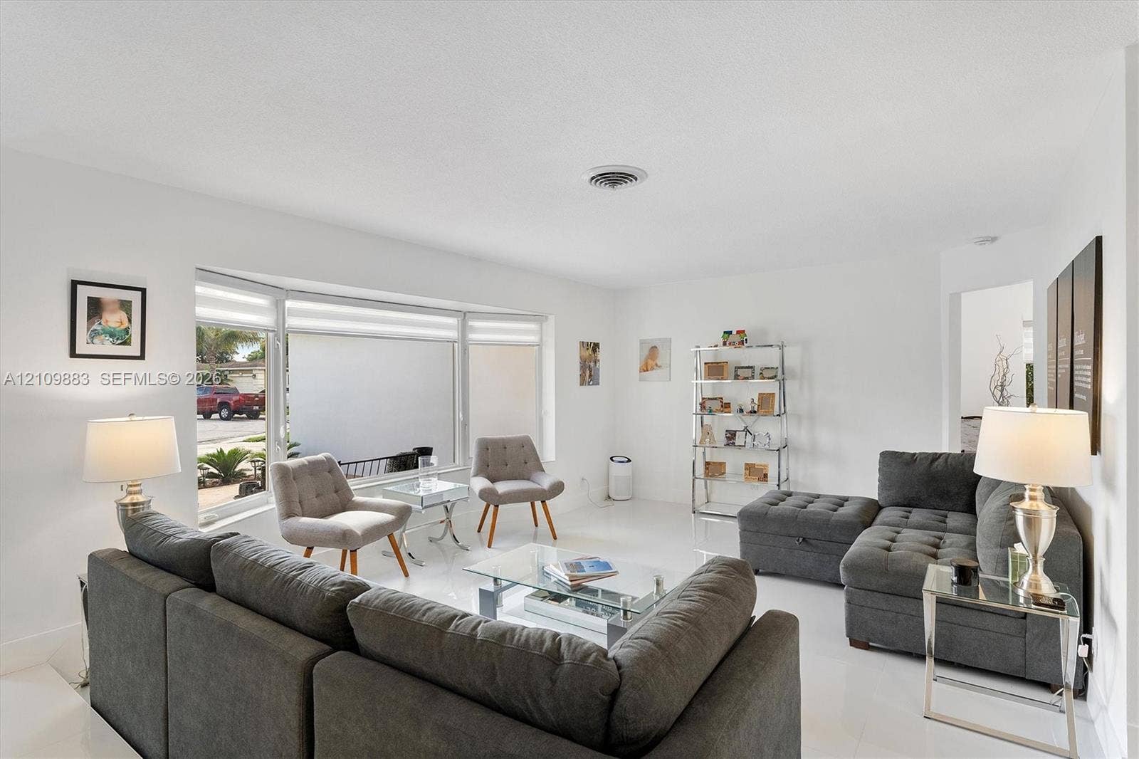 751 SW 54th Avenue, Margate, FL 33068 Expansive living space featuring neutral wall finishes, polished tile flooring, and a large bay window