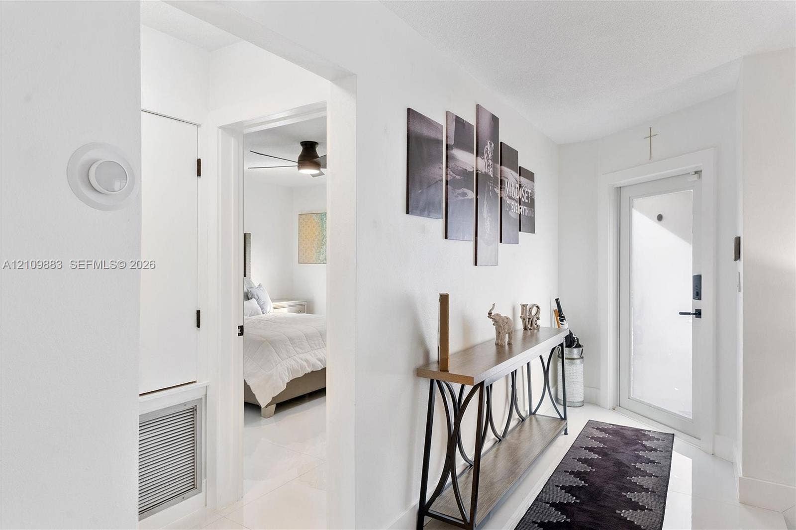 751 SW 54th Avenue, Margate, FL 33068 Entryway featuring crisp white walls, neutral tile flooring, a glass-panel entry door, and a built-in ventilation intake