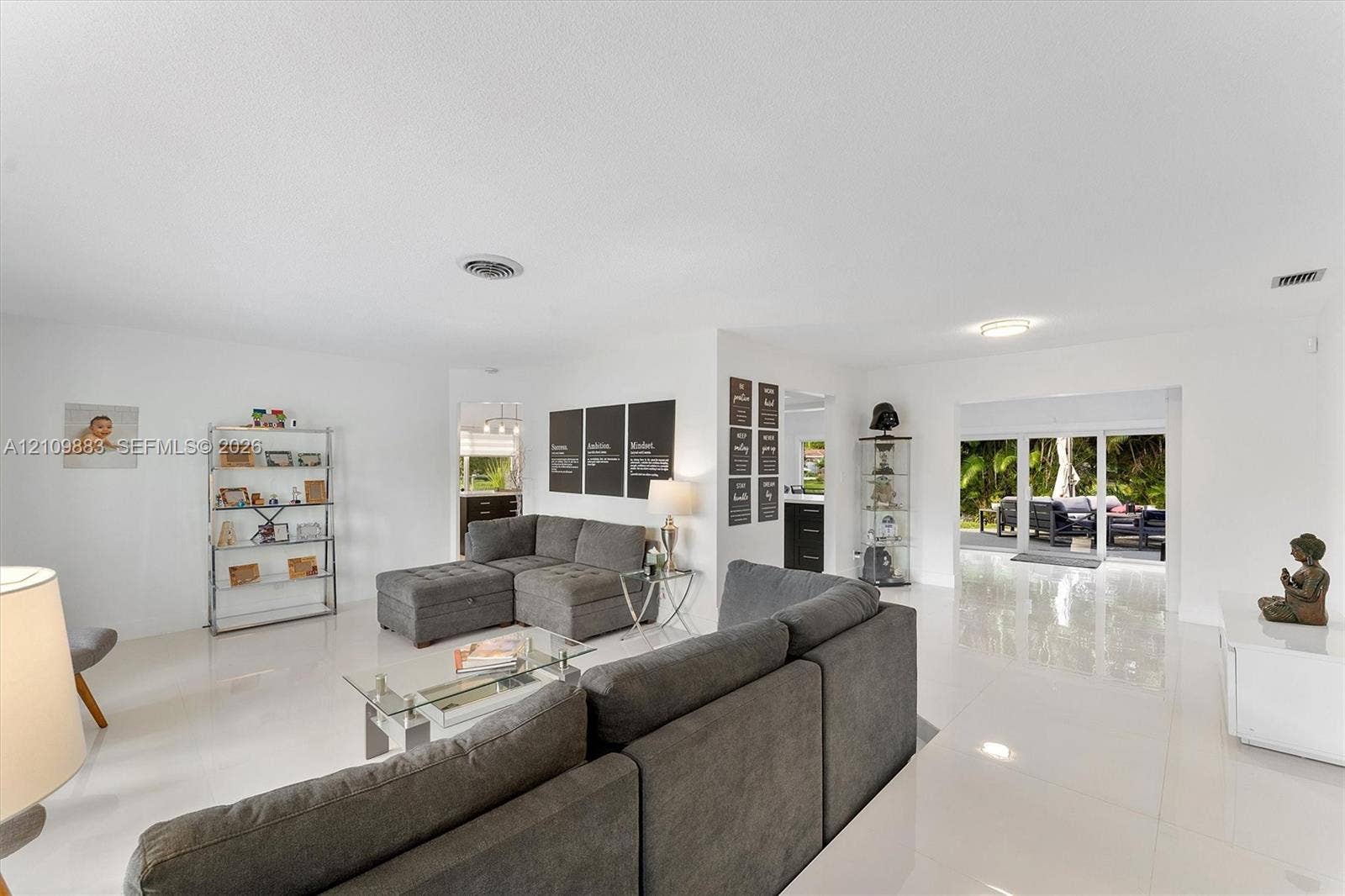 751 SW 54th Avenue, Margate, FL 33068 Open-concept interior featuring polished tile flooring, recessed ceiling lighting, and large sliding glass doors providing outdoor access