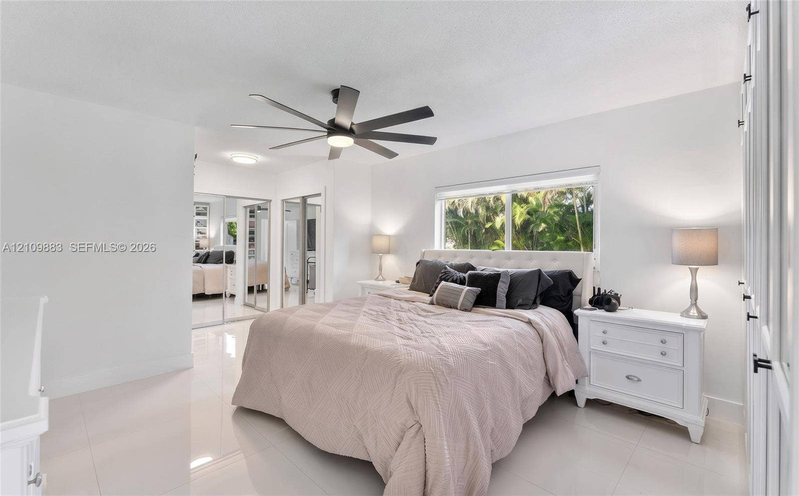 751 SW 54th Avenue, Margate, FL 33068 Spacious room featuring polished tile flooring, a multi-blade ceiling fan, and mirrored sliding closet doors