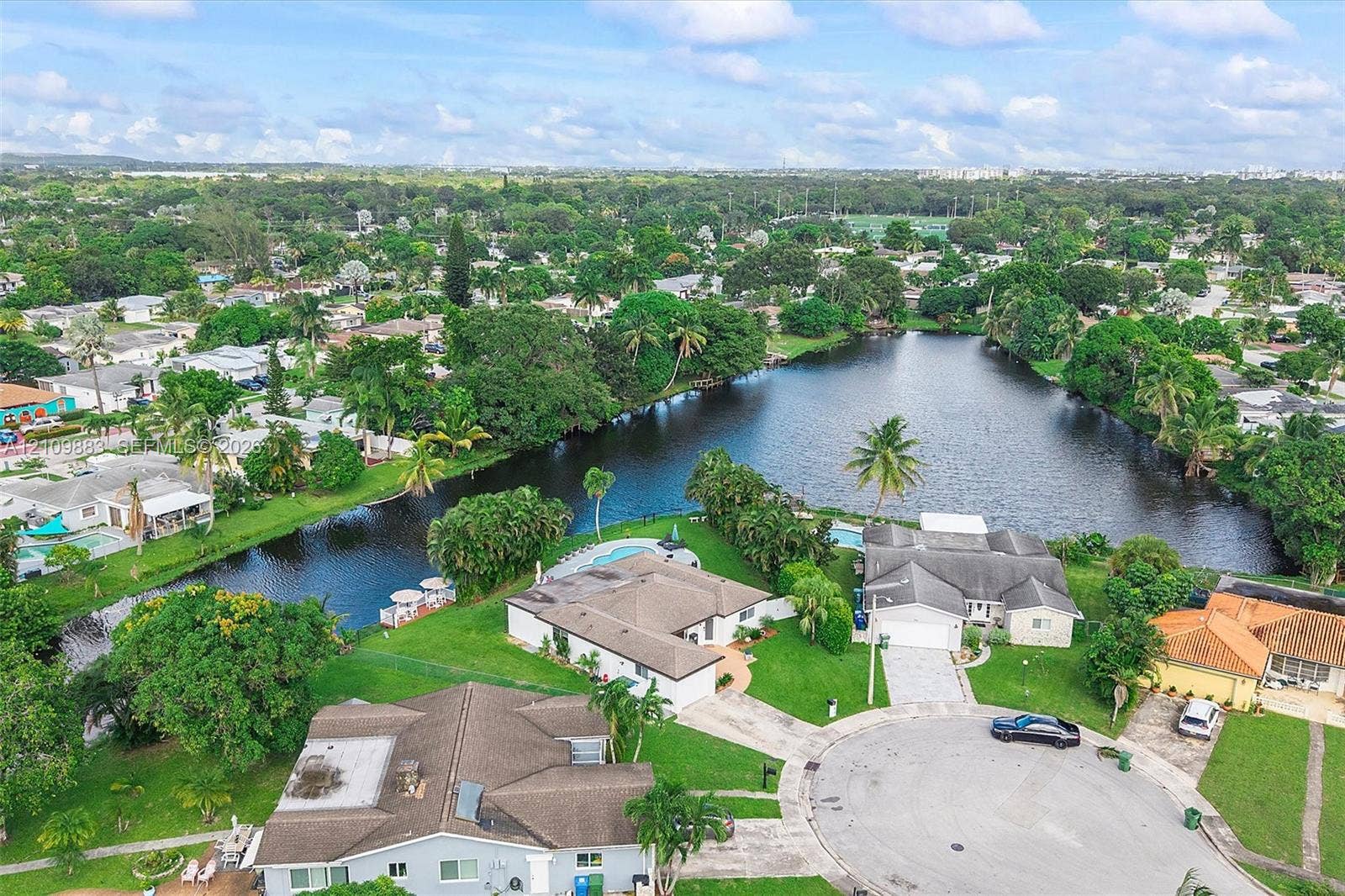751 SW 54th Avenue, Margate, FL 33068 Aerial perspective featuring expansive waterfront positioning, cul-de-sac placement, mature landscaping, and private in-ground pools