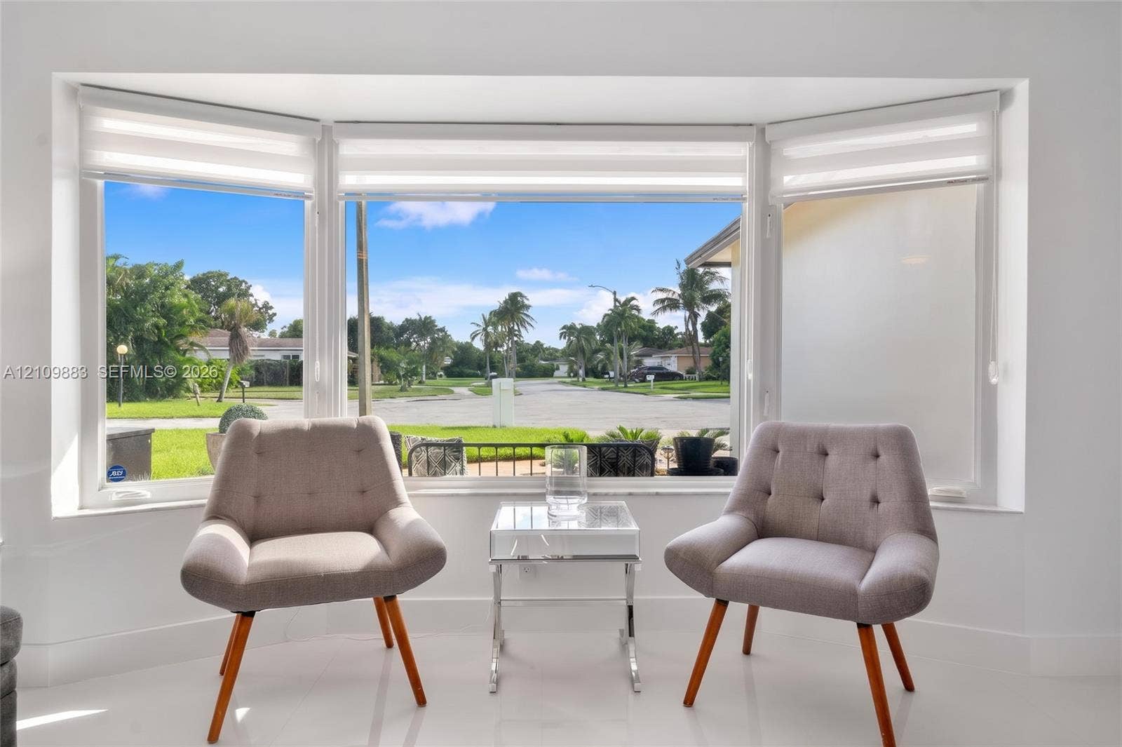 751 SW 54th Avenue, Margate, FL 33068 Large bay window featuring crisp white framing, integrated roller shades, and neutral polished flooring