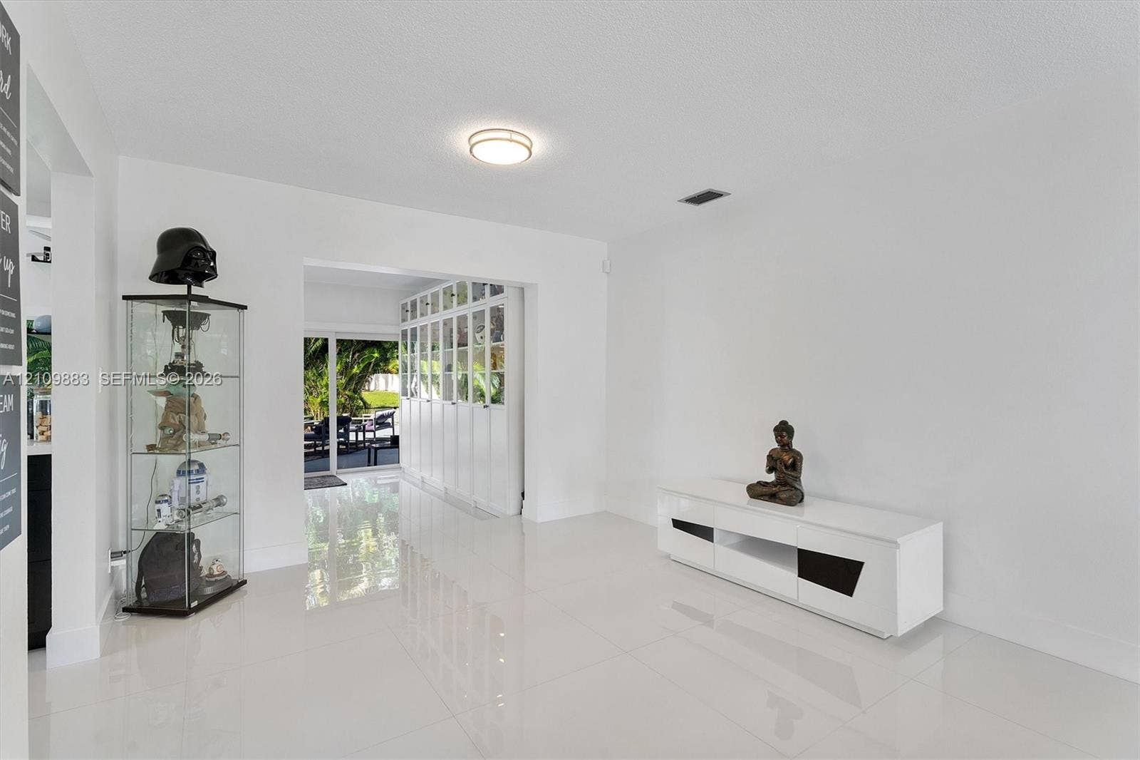 751 SW 54th Avenue, Margate, FL 33068 Interior space featuring polished tile flooring, recessed ceiling lighting, and floor-to-ceiling multi-panel built-in cabinetry