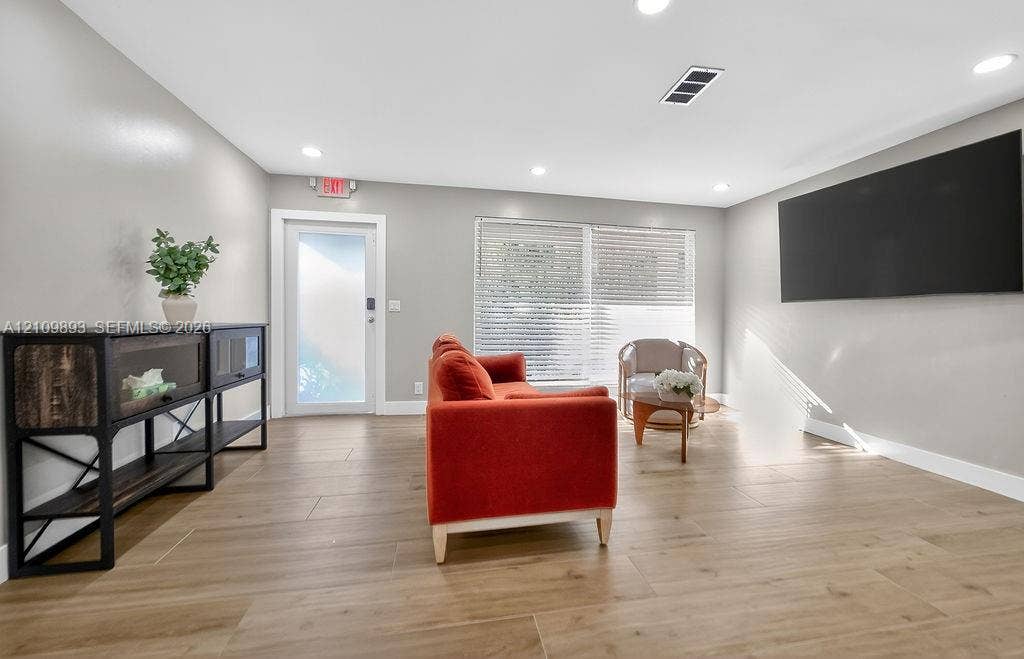 712 Tradewind Drive, North Palm Beach, North Palm Beach, FL 33408 Open floor plan featuring wood-finish flooring, recessed lighting, and horizontal window blinds