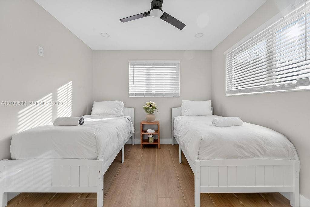712 Tradewind Drive, North Palm Beach, North Palm Beach, FL 33408 Neutral-toned walls paired with wood-finish flooring, featuring recessed ceiling lighting, a matte black ceiling fan, and horizontal window blinds