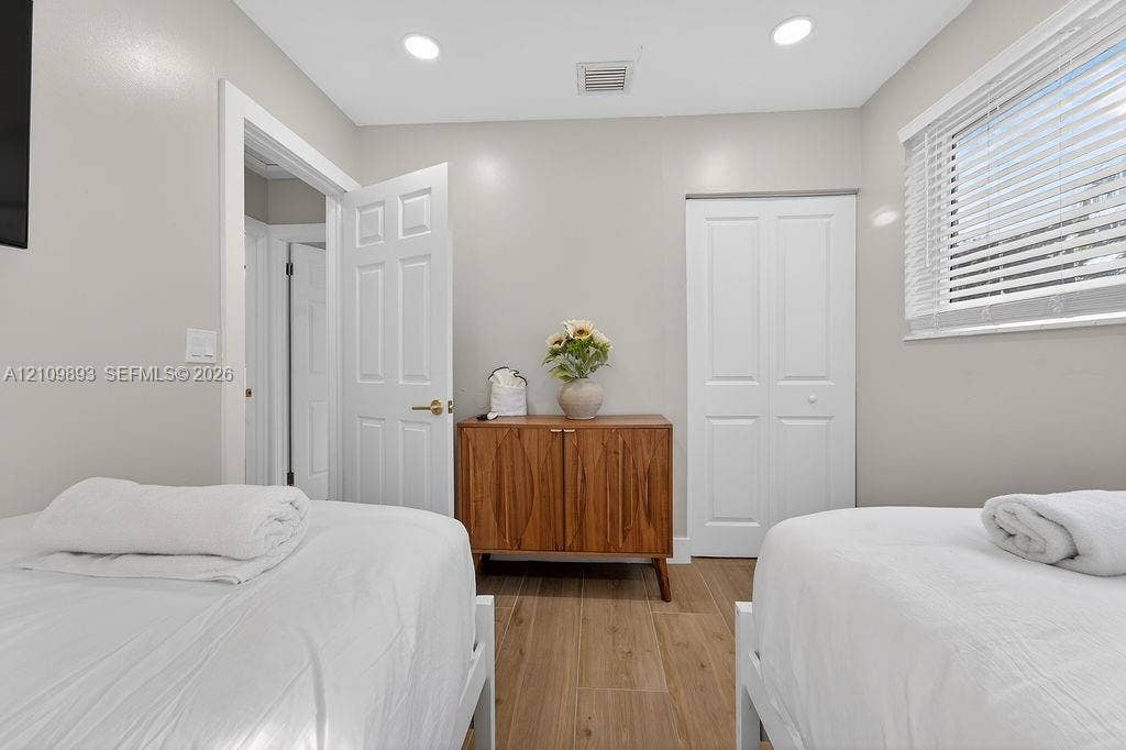 712 Tradewind Drive, North Palm Beach, North Palm Beach, FL 33408 Neutral-toned room featuring wood-finish flooring, recessed lighting, and a closet with double-panel doors