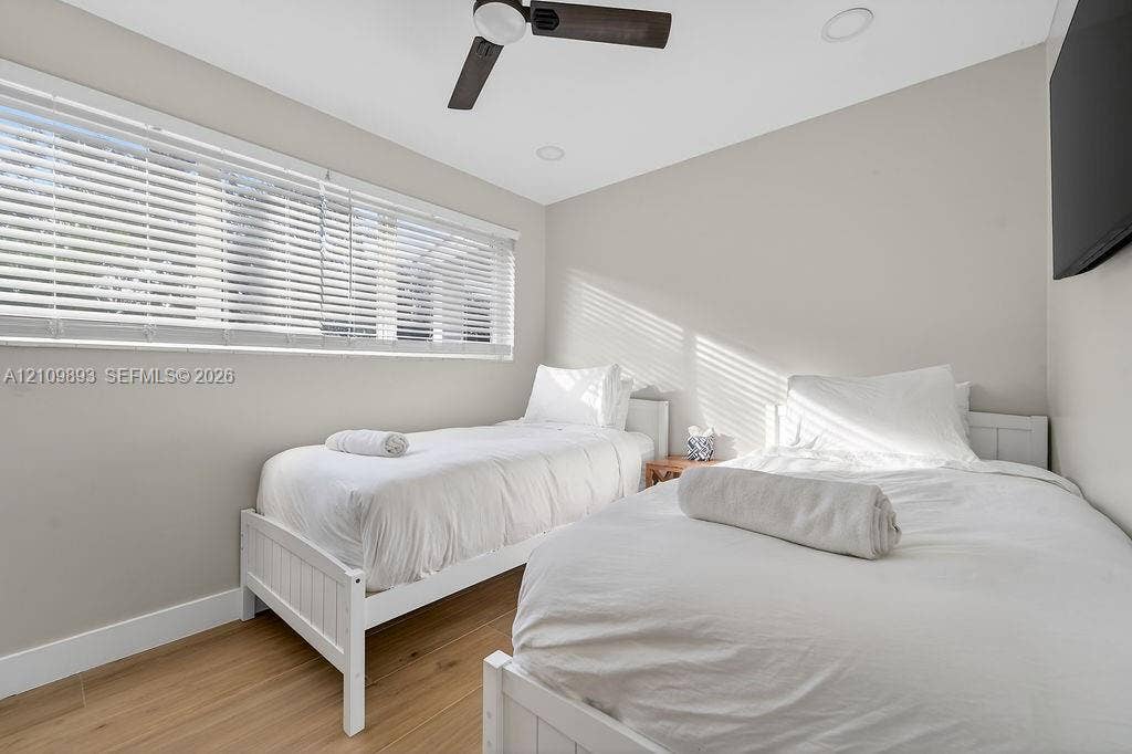 712 Tradewind Drive, North Palm Beach, North Palm Beach, FL 33408 Wood-finish flooring, recessed lighting, ceiling fan with integrated light, and large horizontal window with fitted blinds