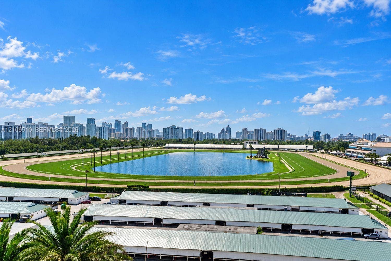 1170 E Hallandale Beach Boulevard, #908, Hallandale Beach, FL 33009 Aerial perspective featuring a racetrack, central water feature, and expansive skyline backdrop