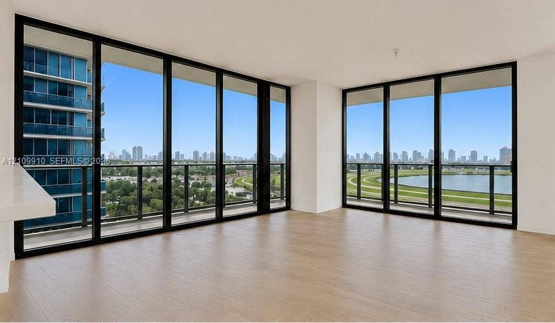1170 E Hallandale Beach Boulevard, #908, Hallandale Beach, FL 33009 Floor-to-ceiling windows with black frames, wood-finish flooring, and expansive wrap-around balconies