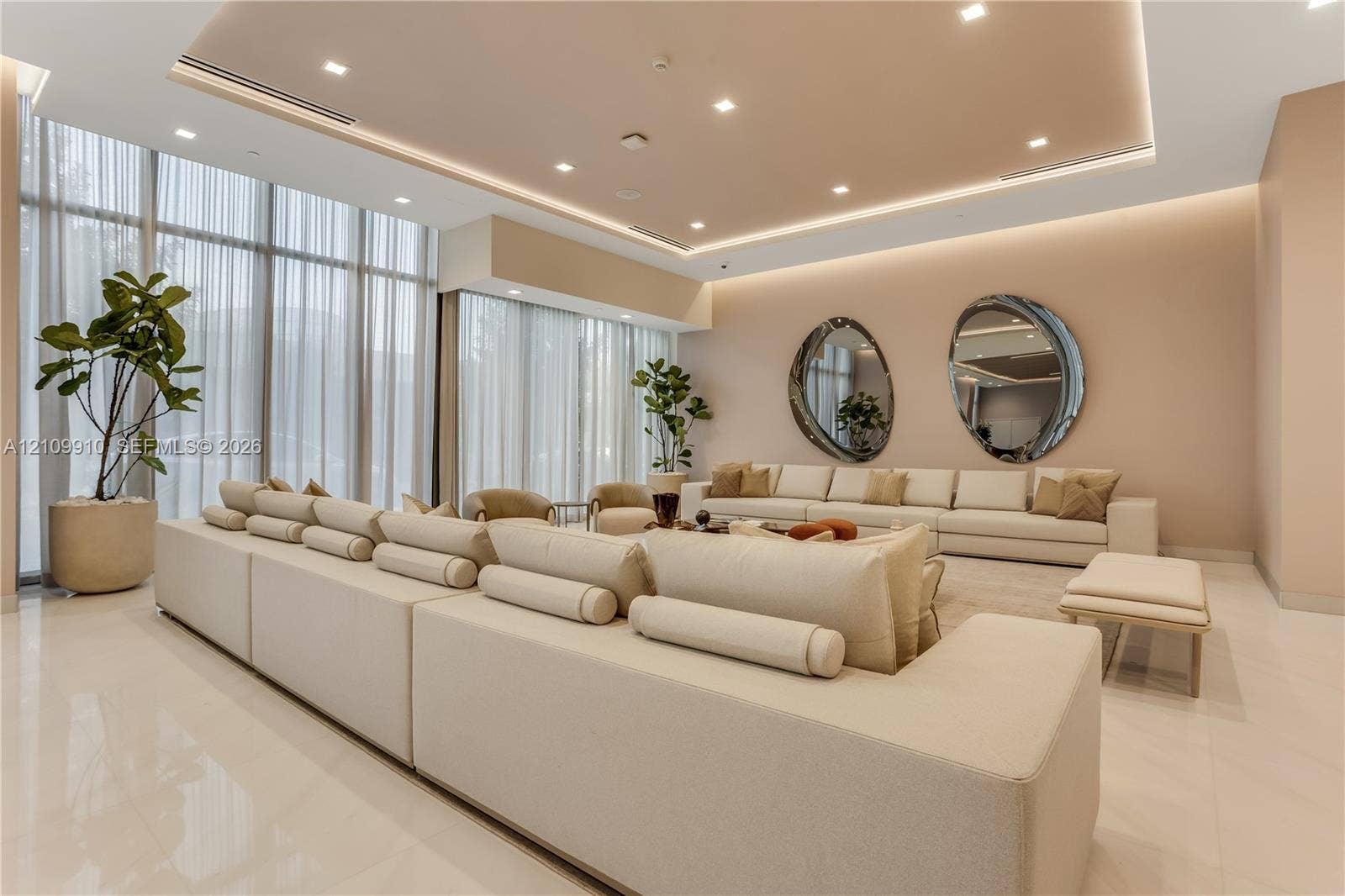 1170 E Hallandale Beach Boulevard, #908, Hallandale Beach, FL 33009 Floor-to-ceiling windows with floor-length drapery, recessed tray ceiling with integrated cove lighting, recessed ceiling lights, and polished stone flooring