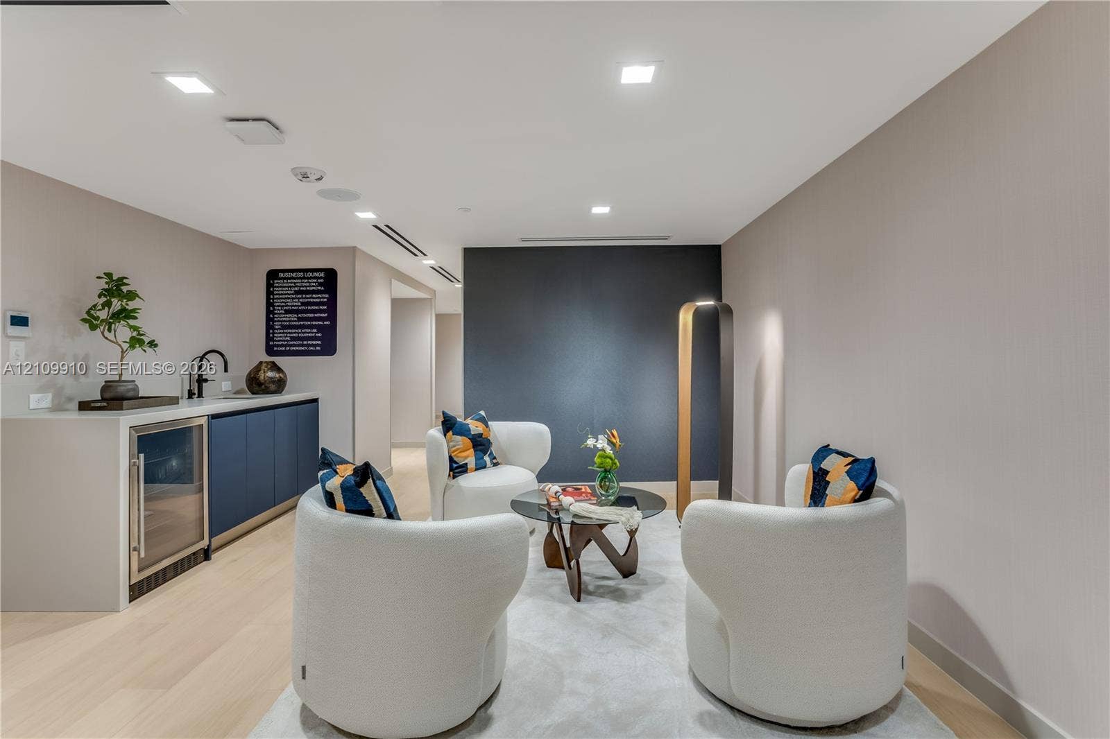1170 E Hallandale Beach Boulevard, #908, Hallandale Beach, FL 33009 Wet bar featuring navy cabinetry, solid surface countertop, built-in beverage refrigerator, and matte black faucet, accented by recessed lighting and light wood-finish flooring