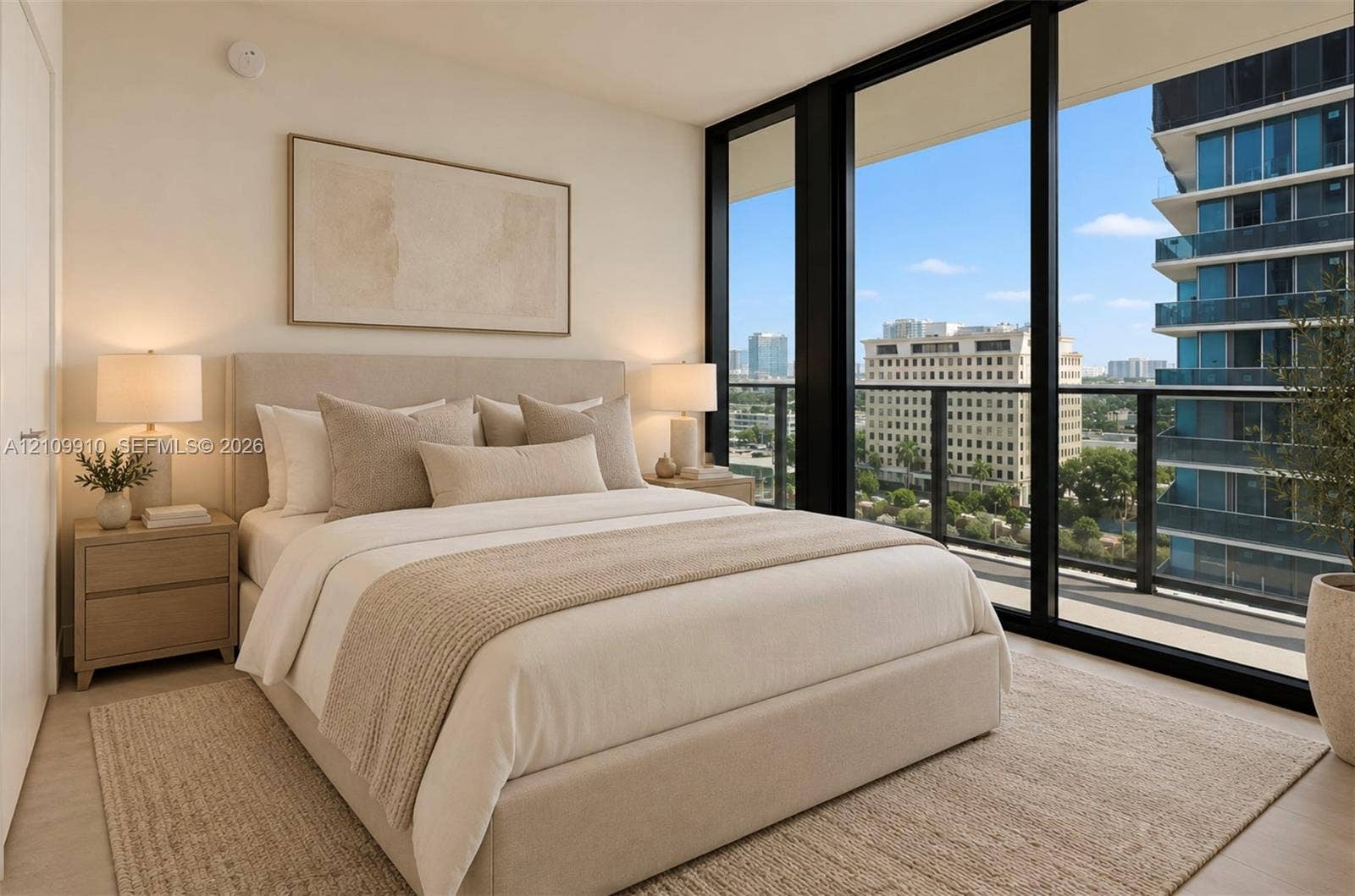 1170 E Hallandale Beach Boulevard, #908, Hallandale Beach, FL 33009 Floor-to-ceiling windows featuring urban scenery and access to an exterior balcony with a metal railing, complemented by neutral-toned interior walls and wood-finish flooring