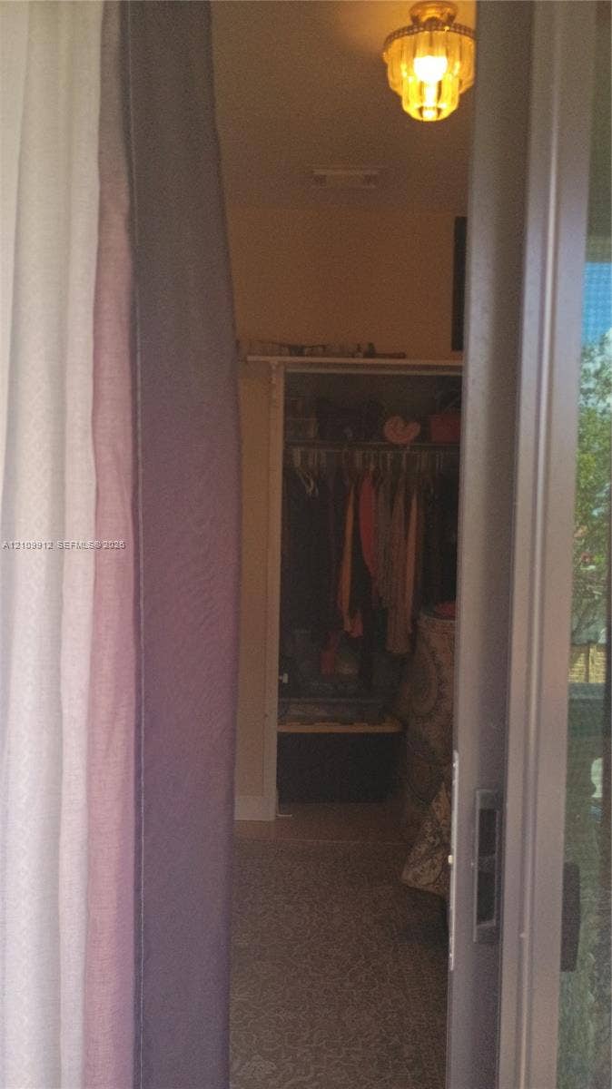 3253 SW 150 Court, Miami, FL 33185 Flush-mount tiered glass ceiling fixture and built-in closet with integrated hanging rod and shelf