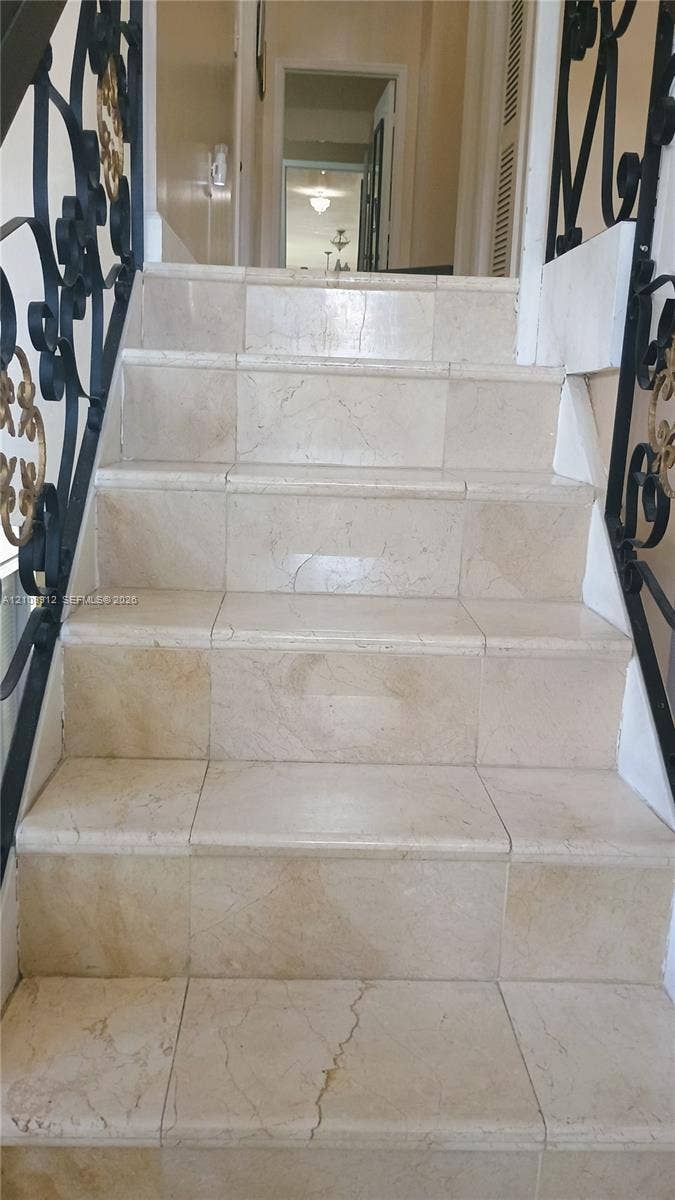 3253 SW 150 Court, Miami, FL 33185 Staircase featuring stone-finish treads and risers with ornate black metal railings