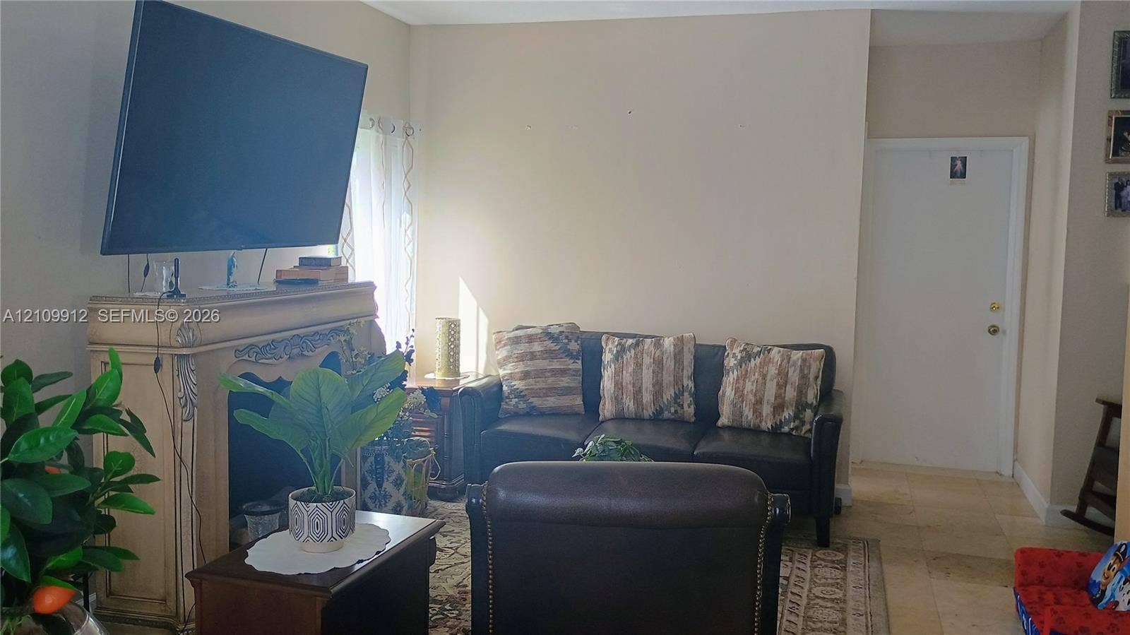 3253 SW 150 Court, Miami, FL 33185 Fireplace featuring decorative molding and stone-tile flooring
