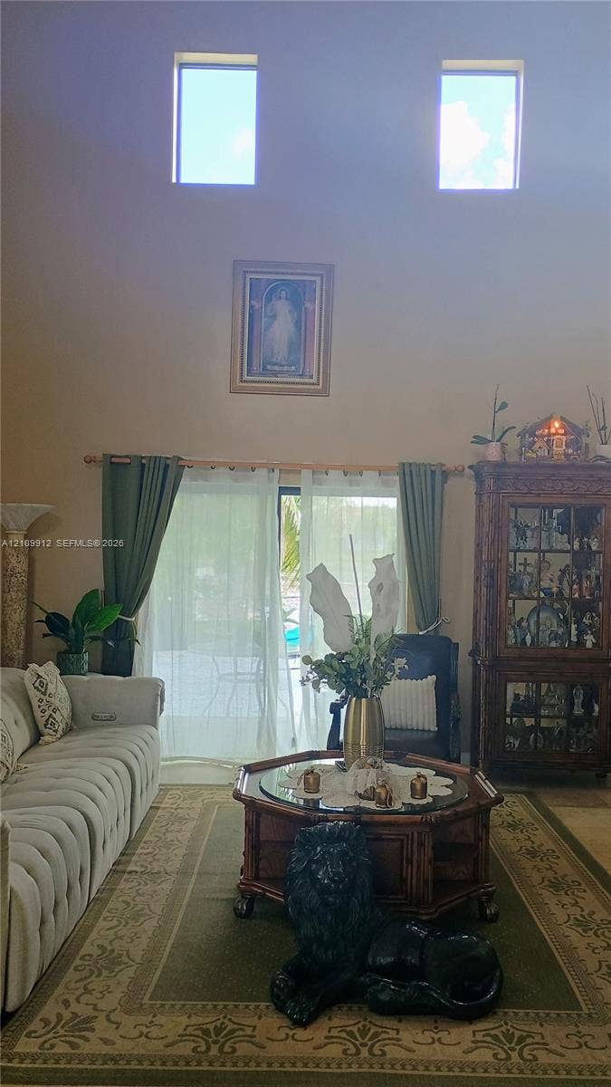 3253 SW 150 Court, Miami, FL 33185 High ceilings featuring dual clerestory windows and sliding glass door access to the exterior