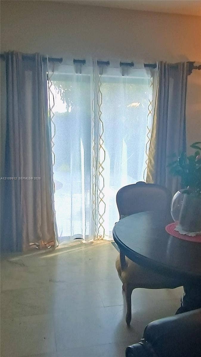 3253 SW 150 Court, Miami, FL 33185 Sliding glass door with neutral stone-finish flooring