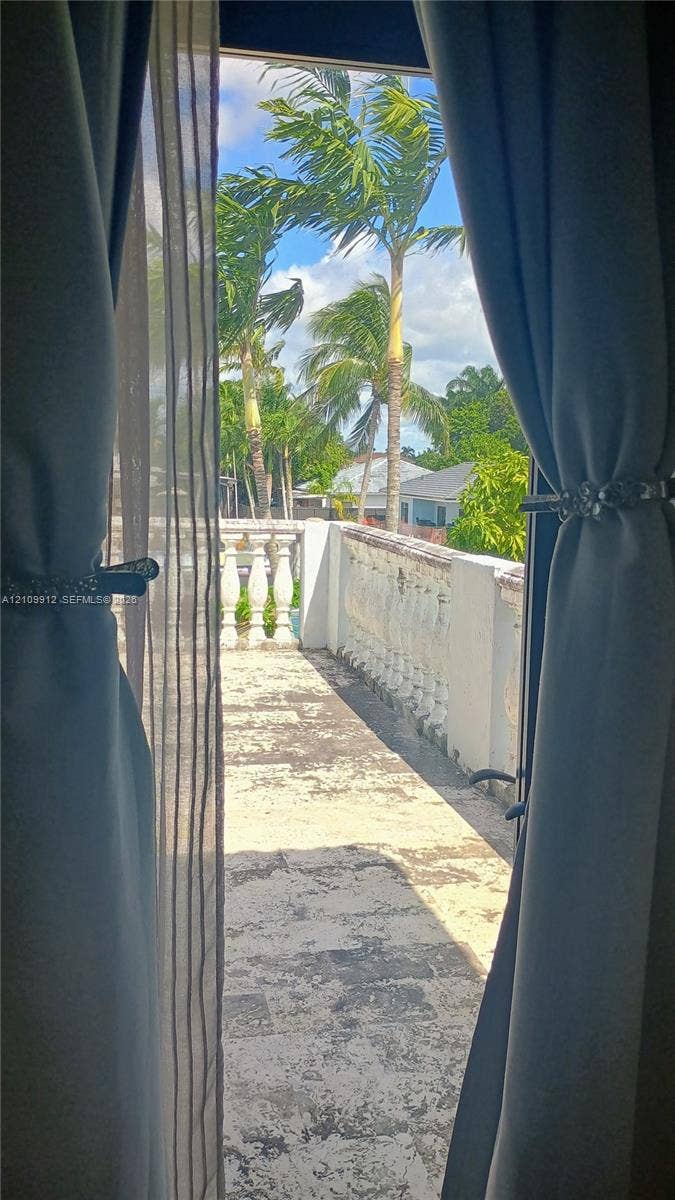 3253 SW 150 Court, Miami, FL 33185 Exterior terrace featuring stone tile flooring and decorative balustrade railing