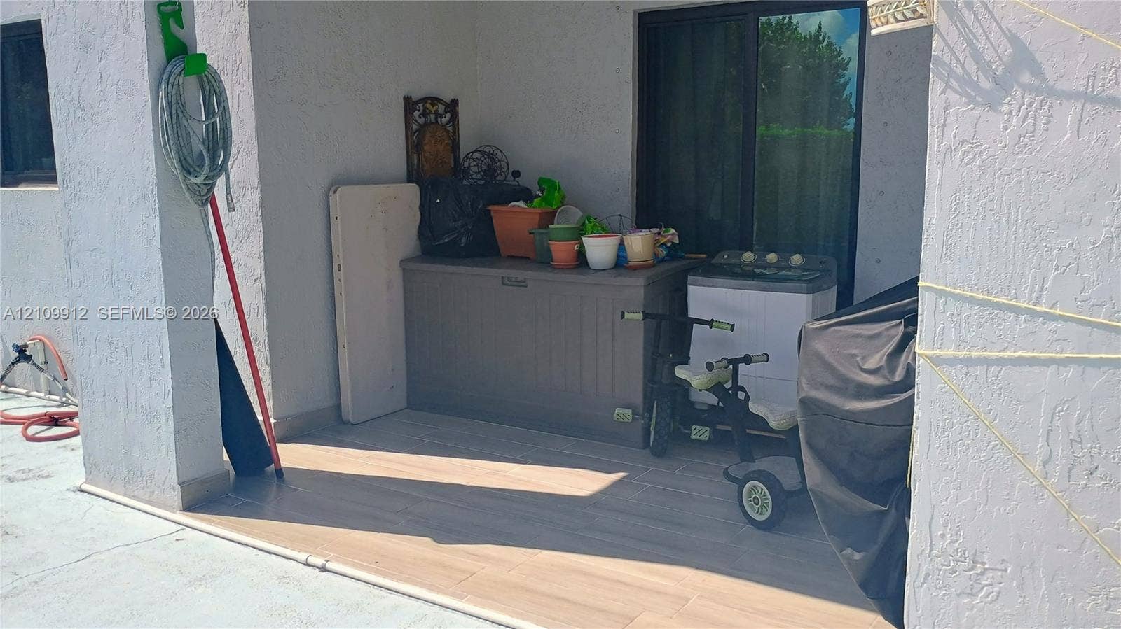 3253 SW 150 Court, Miami, FL 33185 Covered patio featuring wood-finish flooring and sliding glass entry doors