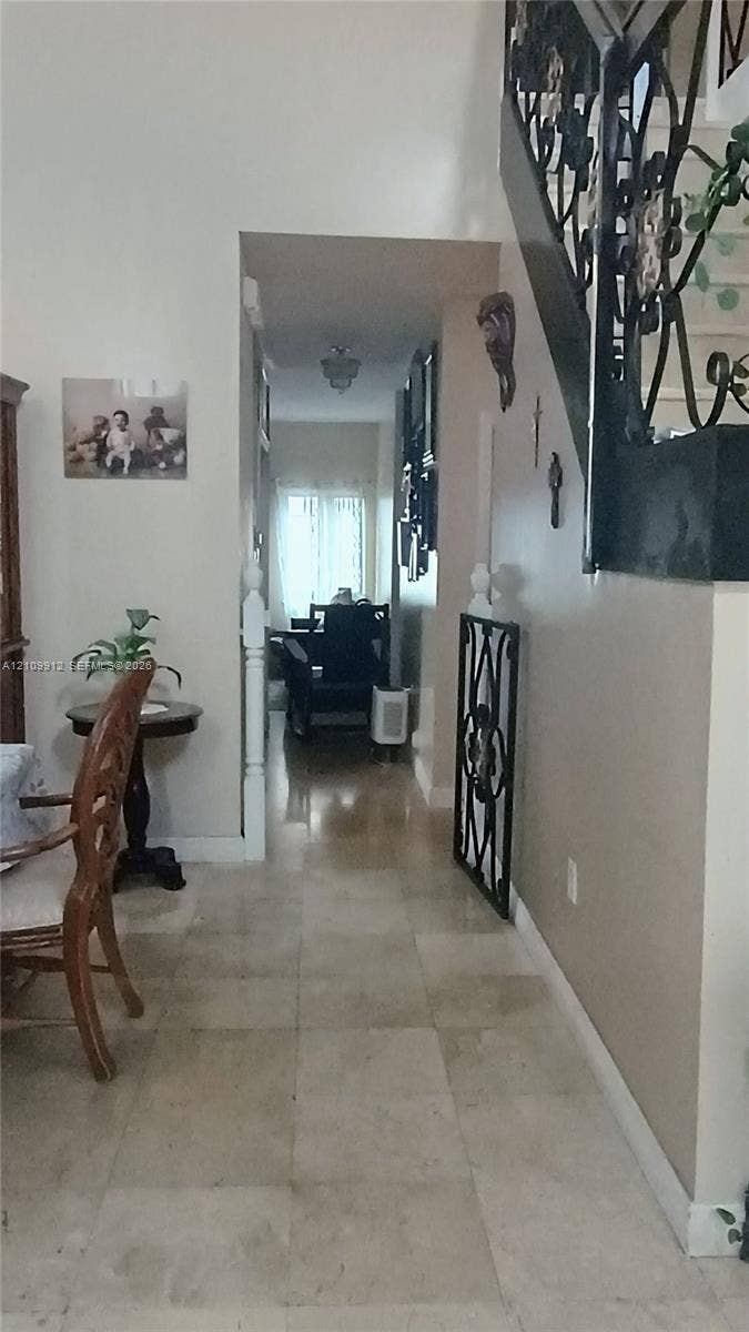 3253 SW 150 Court, Miami, FL 33185 Entry featuring stone-finish flooring and a staircase with decorative wrought-iron railings