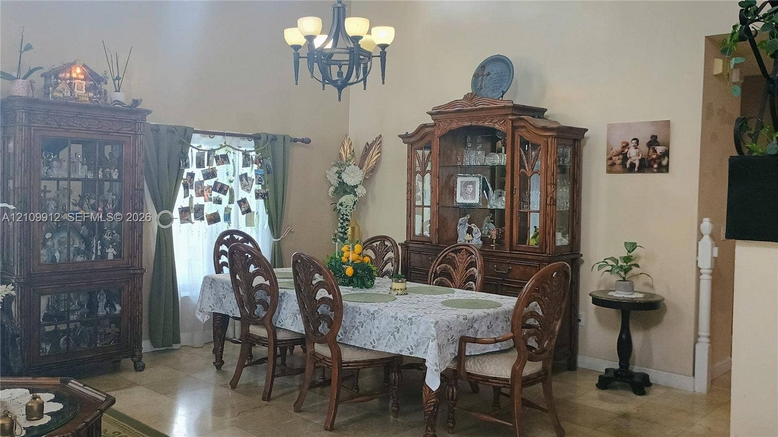 3253 SW 150 Court, Miami, FL 33185 High-ceilinged room featuring natural stone flooring, an intricate metal chandelier, and white-painted interior architectural trim