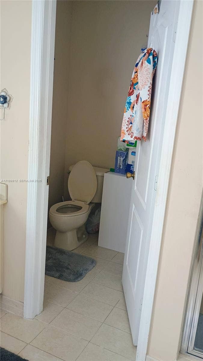 3253 SW 150 Court, Miami, FL 33185 Enclosed water closet featuring tile flooring and a standard white commode