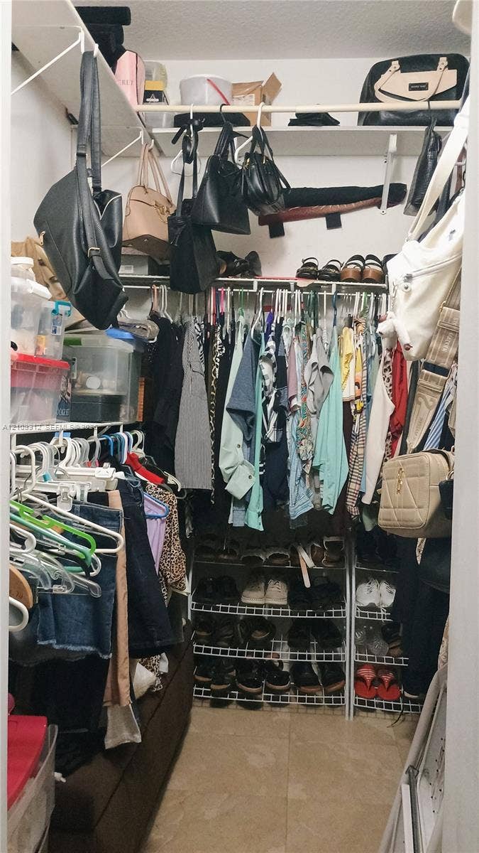 3253 SW 150 Court, Miami, FL 33185 Walk-in closet featuring floor-to-ceiling white wire shelving, multi-level hanging rods, and integrated wire shoe racking