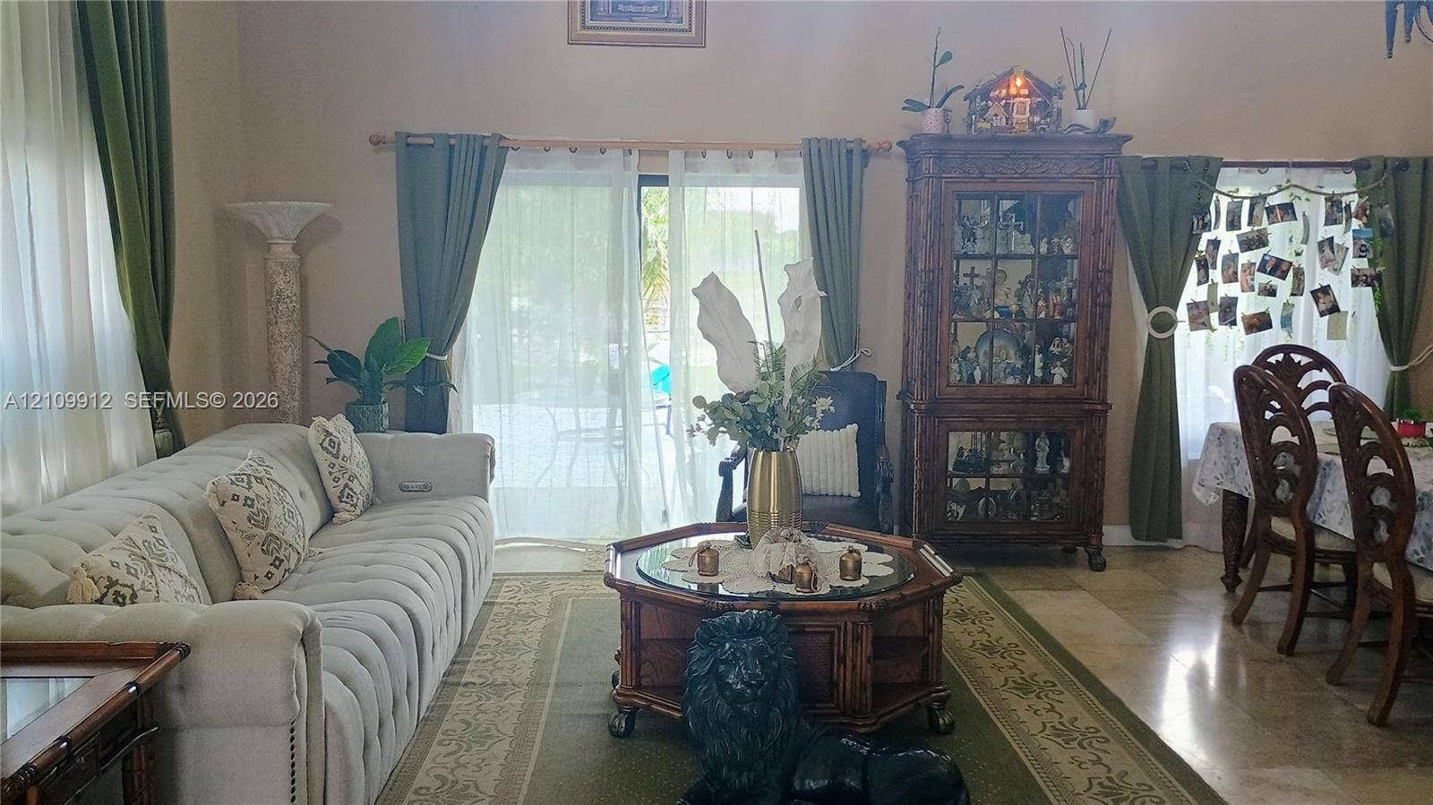 3253 SW 150 Court, Miami, FL 33185 Living area featuring high ceilings, neutral stone-finish flooring, and sliding glass doors