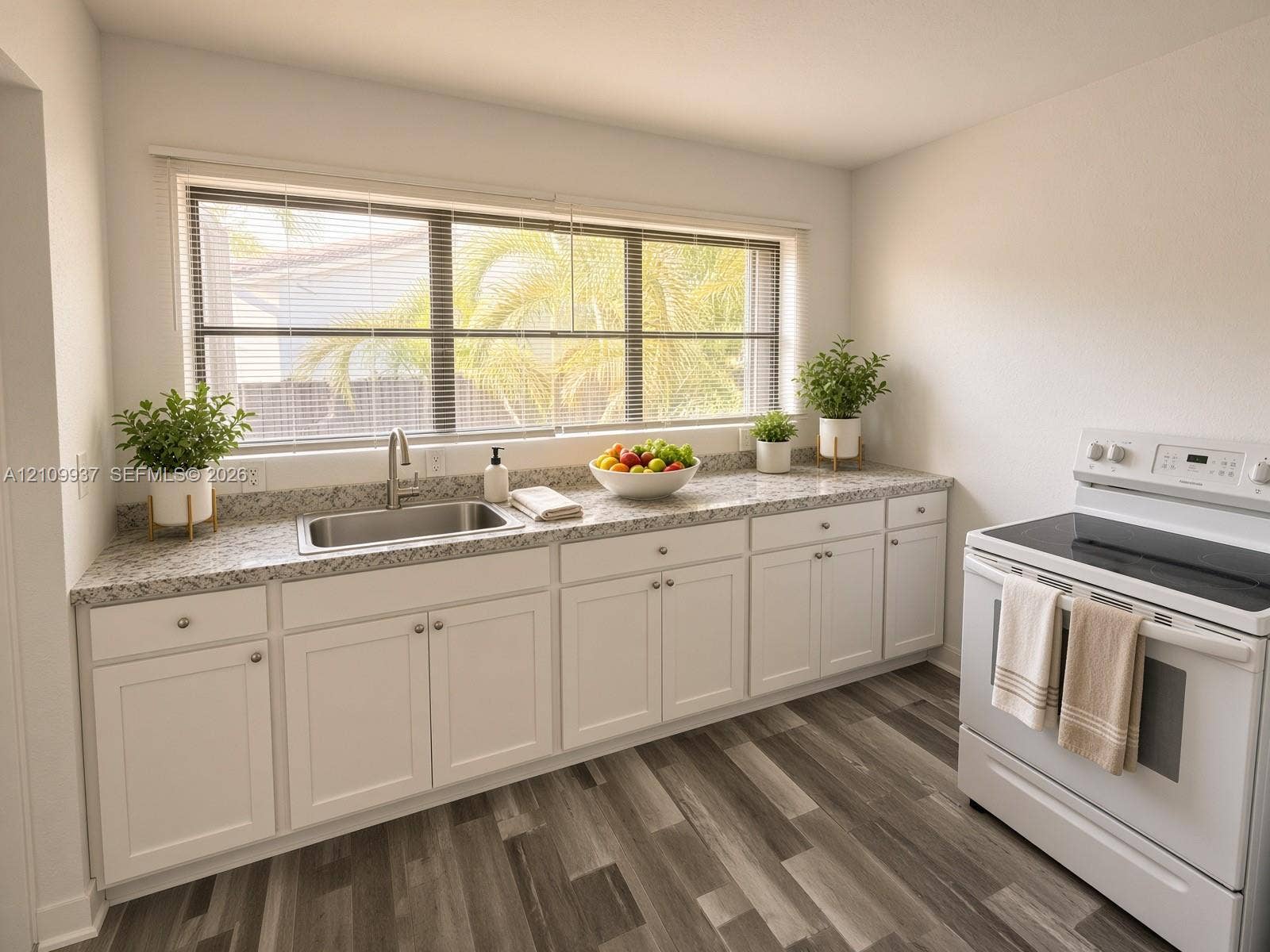1024 Tyler Street, #2, Hollywood, Hollywood, FL 33019 Kitchen featuring white shaker-style cabinetry, stone-finish countertops, stainless steel undermount sink, wood-finish flooring, and a wide window with natural light