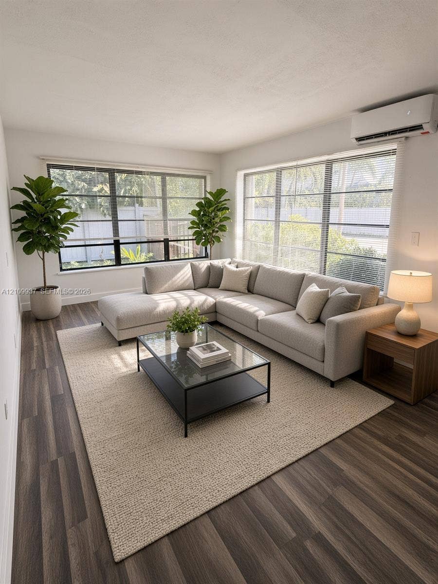 1024 Tyler Street, #2, Hollywood, Hollywood, FL 33019 Living area featuring wood-finish flooring, large multi-pane windows, and a wall-mounted ductless climate control unit