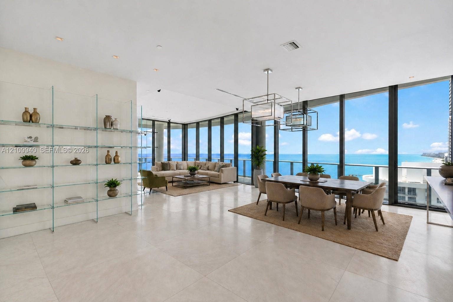 Floor-to-ceiling glass walls, expansive tile flooring, custom built-in glass shelving, and geometric pendant lighting