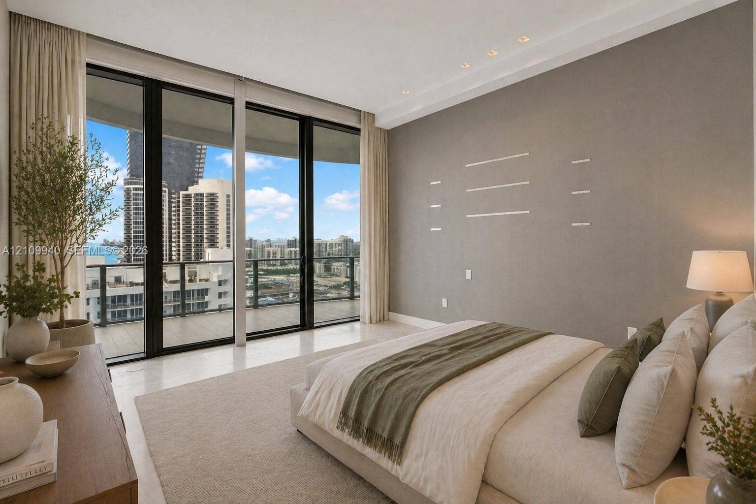 Floor-to-ceiling glass wall, recessed ceiling lighting, neutral interior palette, and balcony access
