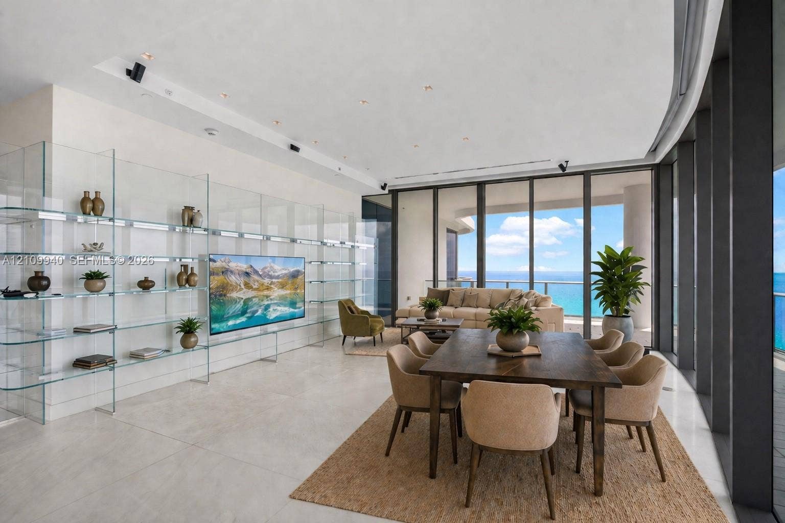 Open-concept living area featuring floor-to-ceiling glass walls, large-format stone-finish flooring, built-in floor-to-ceiling glass shelving, and recessed ceiling lighting