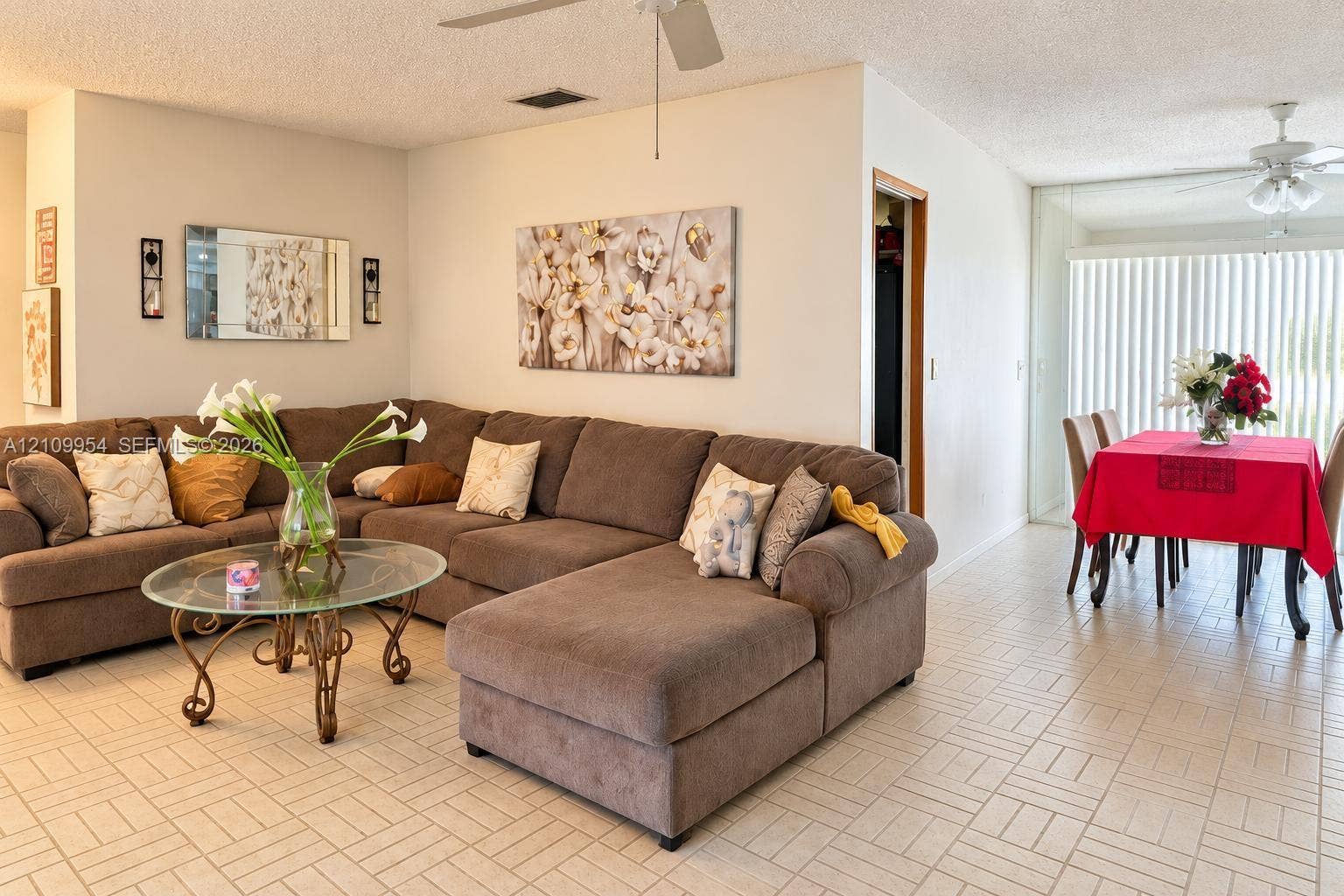 8528 Windsor Drive, Miramar, FL 33025 Ceramic tile flooring, dual ceiling fans with light fixtures, and floor-to-ceiling vertical blinds