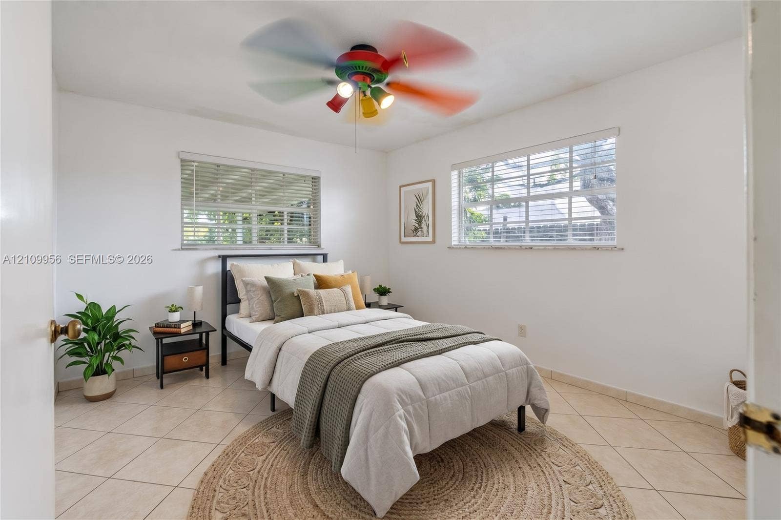 19503 SW 114th Place, Miami, FL 33157 Neutral-toned ceramic tile flooring, dual windows with integrated horizontal blinds, and a multi-light ceiling fan