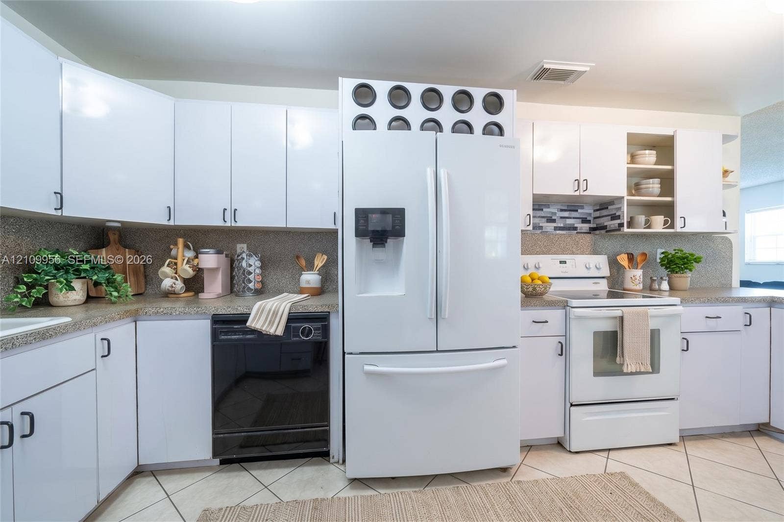 19503 SW 114th Place, Miami, FL 33157 Kitchen featuring white shaker-style cabinetry, neutral stone-finish countertops, tiled backsplash, tile flooring, and integrated white appliances