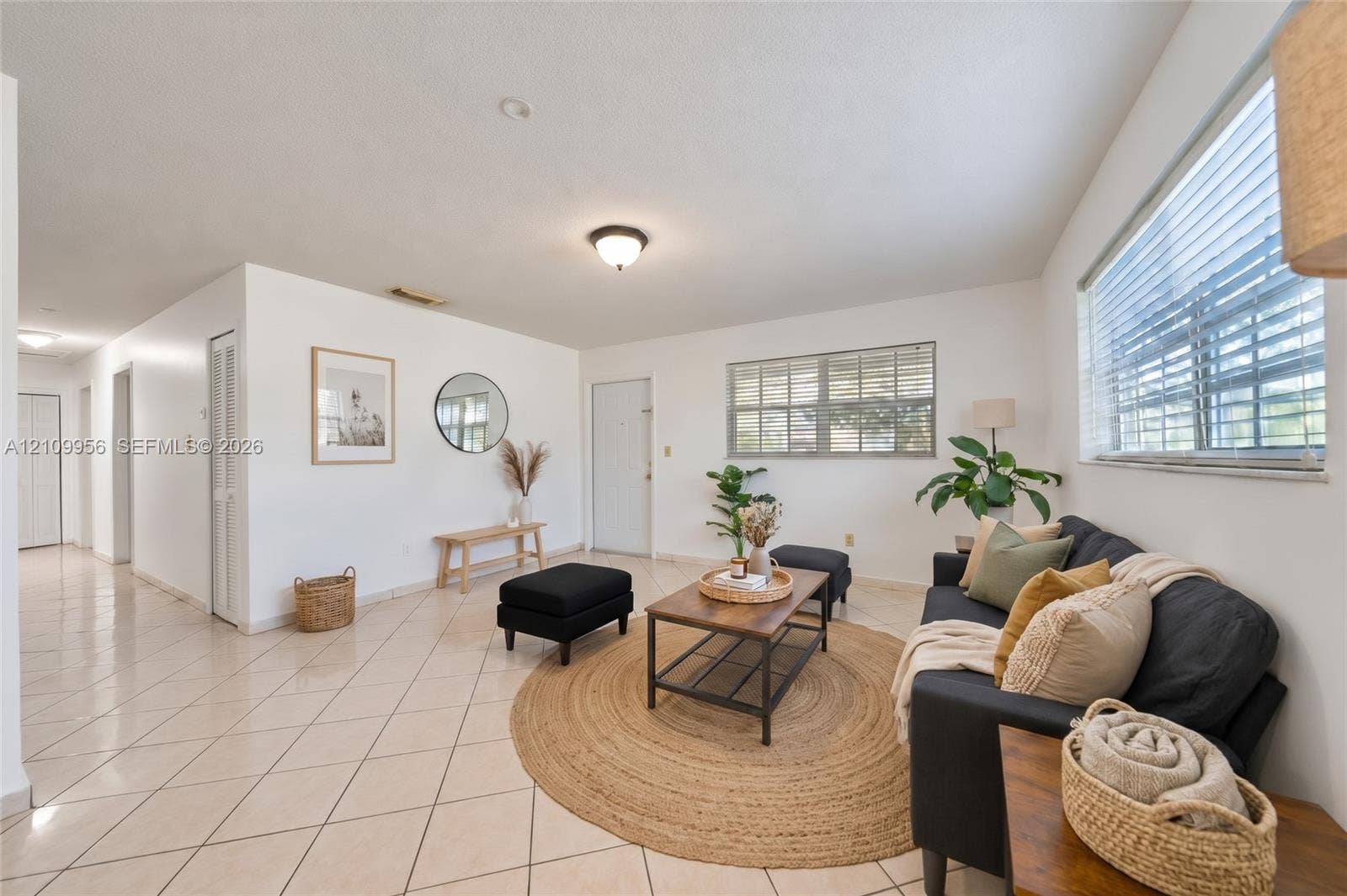 19503 SW 114th Place, Miami, FL 33157 Open-concept interior featuring light-colored diagonal tile flooring, multi-pane windows with horizontal blinds, neutral wall paint, and overhead flush-mount lighting