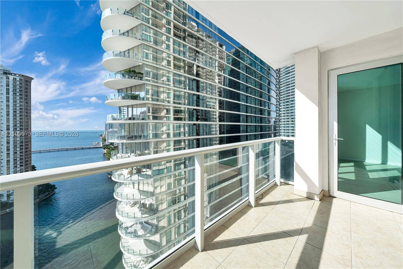 300 S Biscayne Boulevard, #T-1806, Miami, Miami, FL 33131 Covered balcony featuring tile flooring and a glass-paneled railing