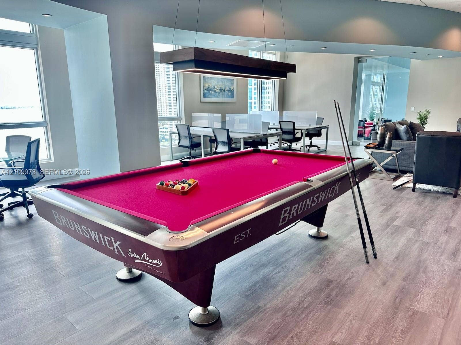 300 S Biscayne Boulevard, #T-1806, Miami, Miami, FL 33131 Open-concept space featuring wood-finish flooring, floor-to-ceiling windows, and a rectangular pendant light fixture with a wood-finished frame
