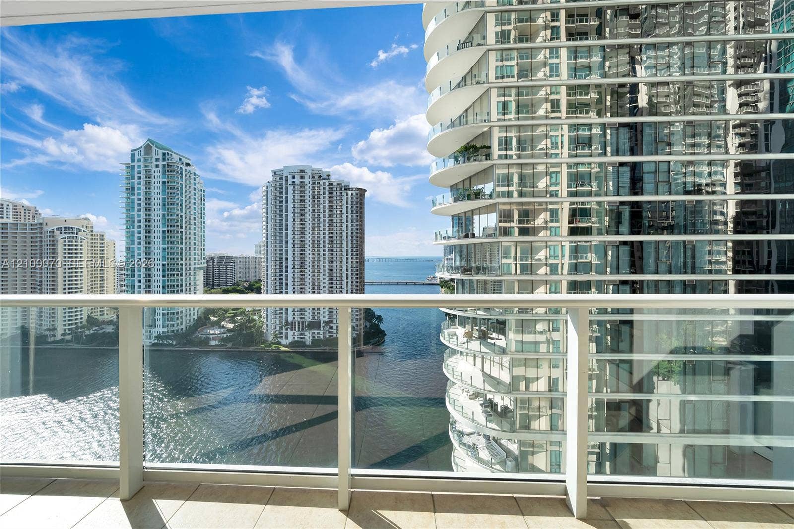 300 S Biscayne Boulevard, #T-1806, Miami, Miami, FL 33131 Private balcony featuring glass panel railing, tile flooring, and urban water scenery