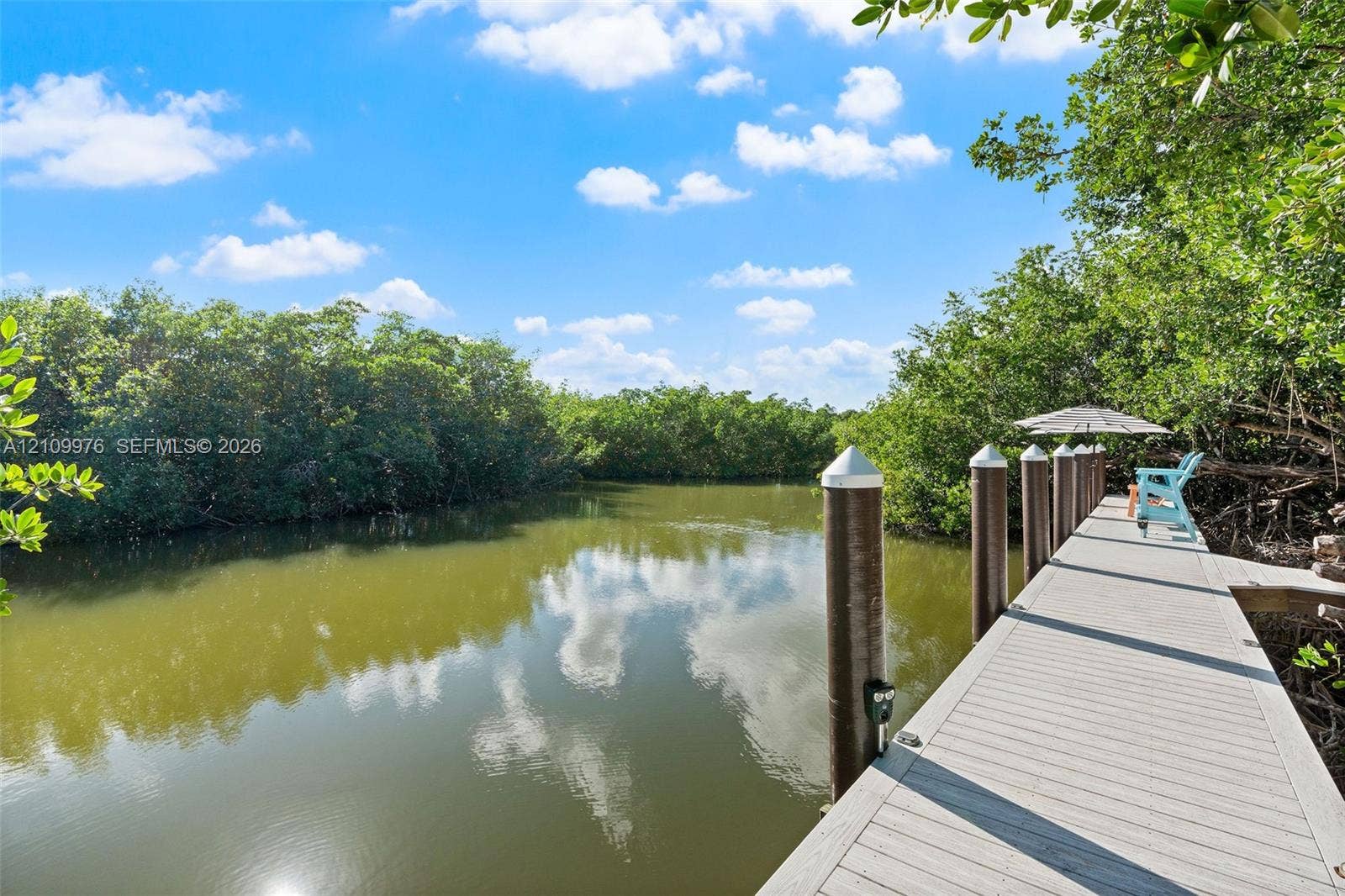 43 Waterways Drive, Key Largo, FL 33037 Waterfront dock featuring composite decking and anchored mooring pilings