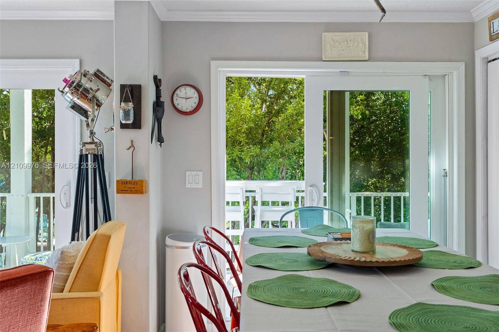 43 Waterways Drive, Key Largo, FL 33037 Dual sliding glass doors with white frames providing exterior access and a white railing balcony