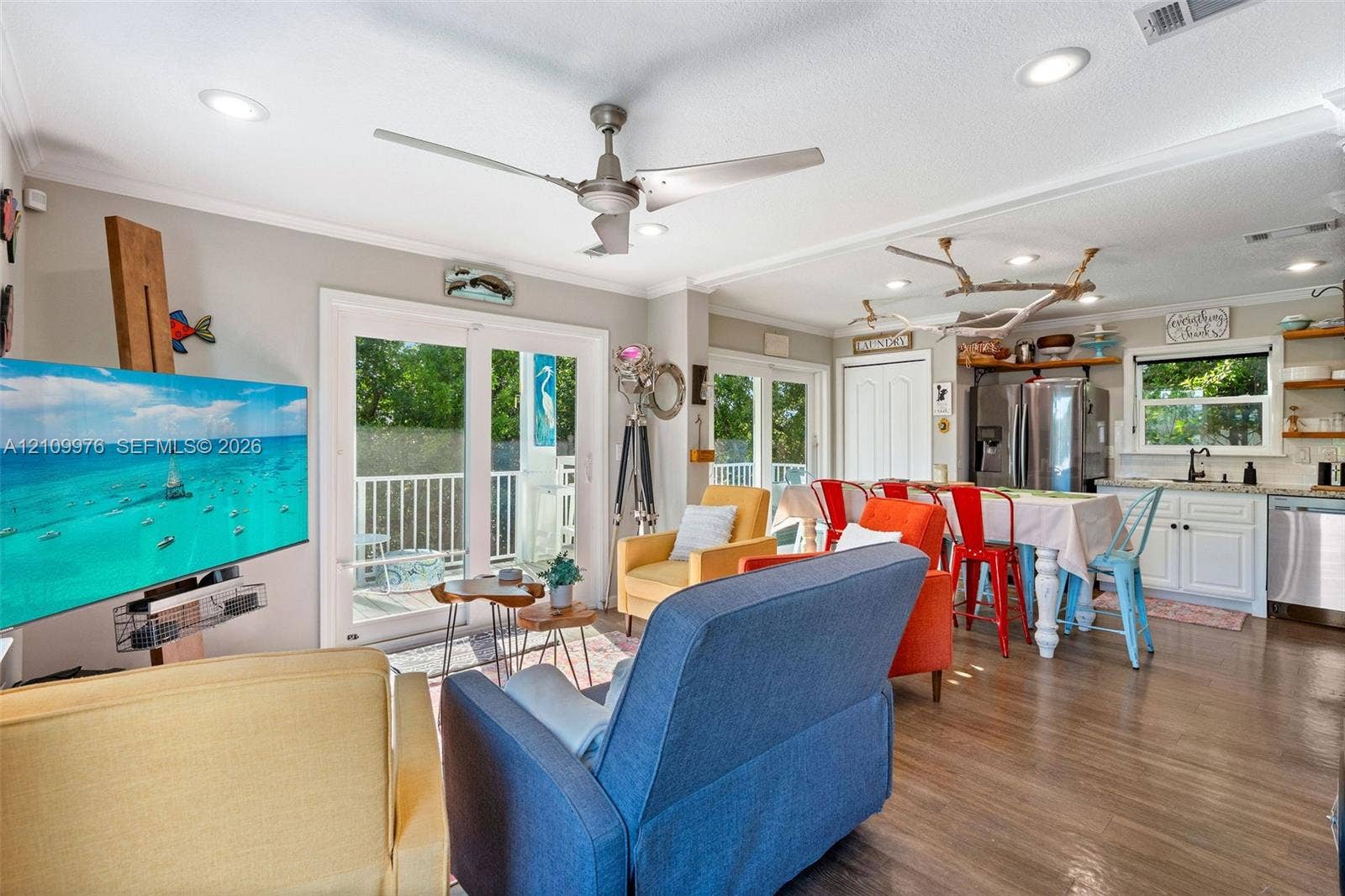 43 Waterways Drive, Key Largo, FL 33037 Open-concept interior featuring wood-finish flooring, recessed lighting, a modern ceiling fan, and sliding glass doors with exterior access