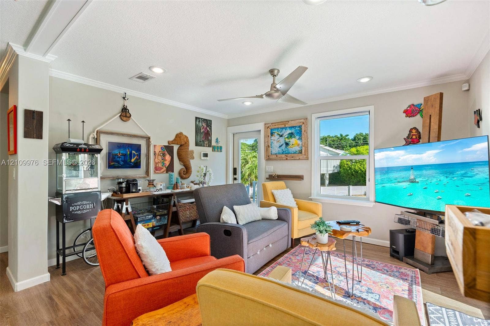 43 Waterways Drive, Key Largo, FL 33037 Living area featuring recessed lighting, a ceiling fan, crown molding, wood-finish flooring, and a single-pane window
