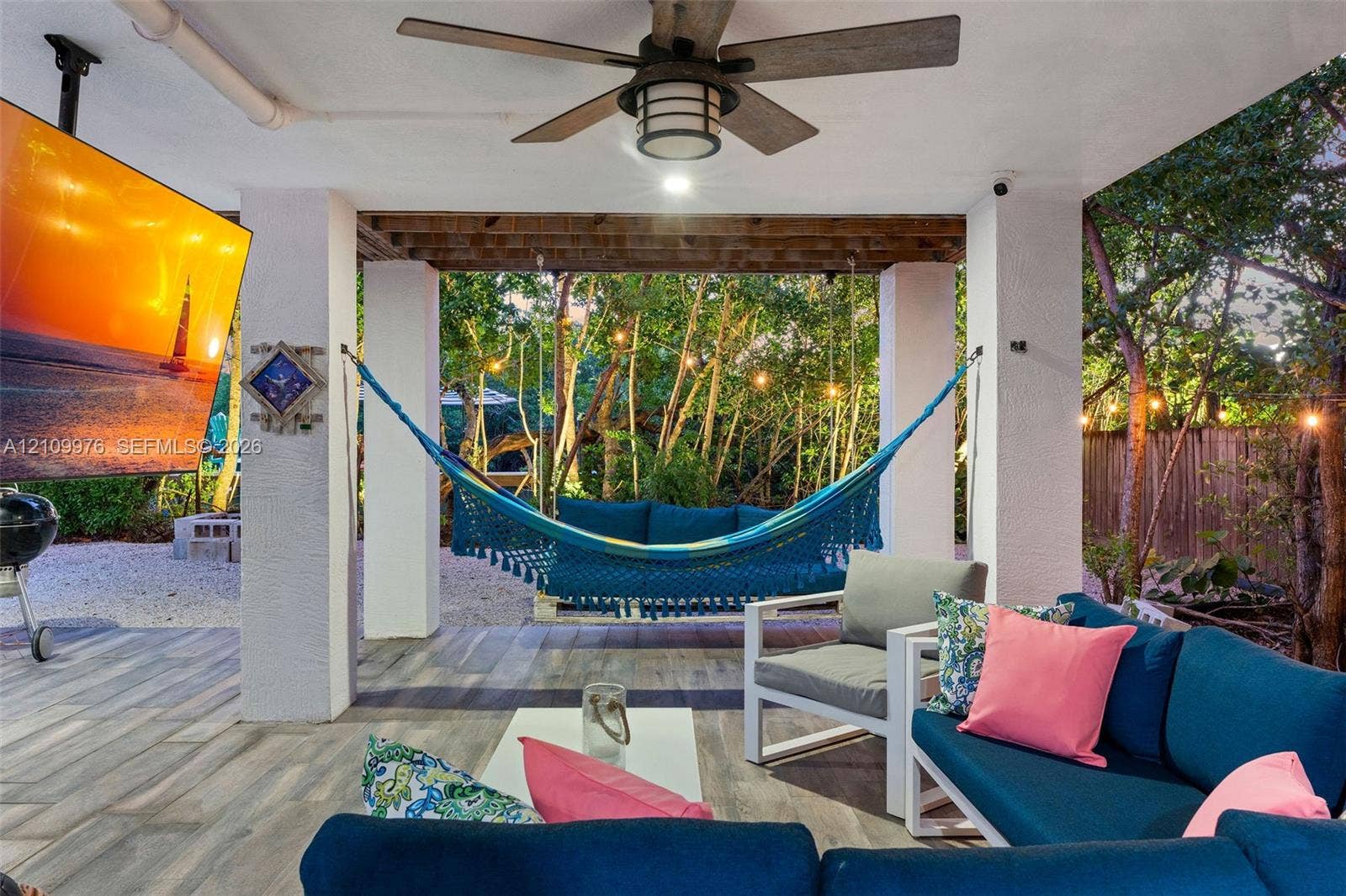 43 Waterways Drive, Key Largo, FL 33037 Covered outdoor patio featuring wood-finish flooring, a ceiling fan with integrated lighting, and substantial structural pillars