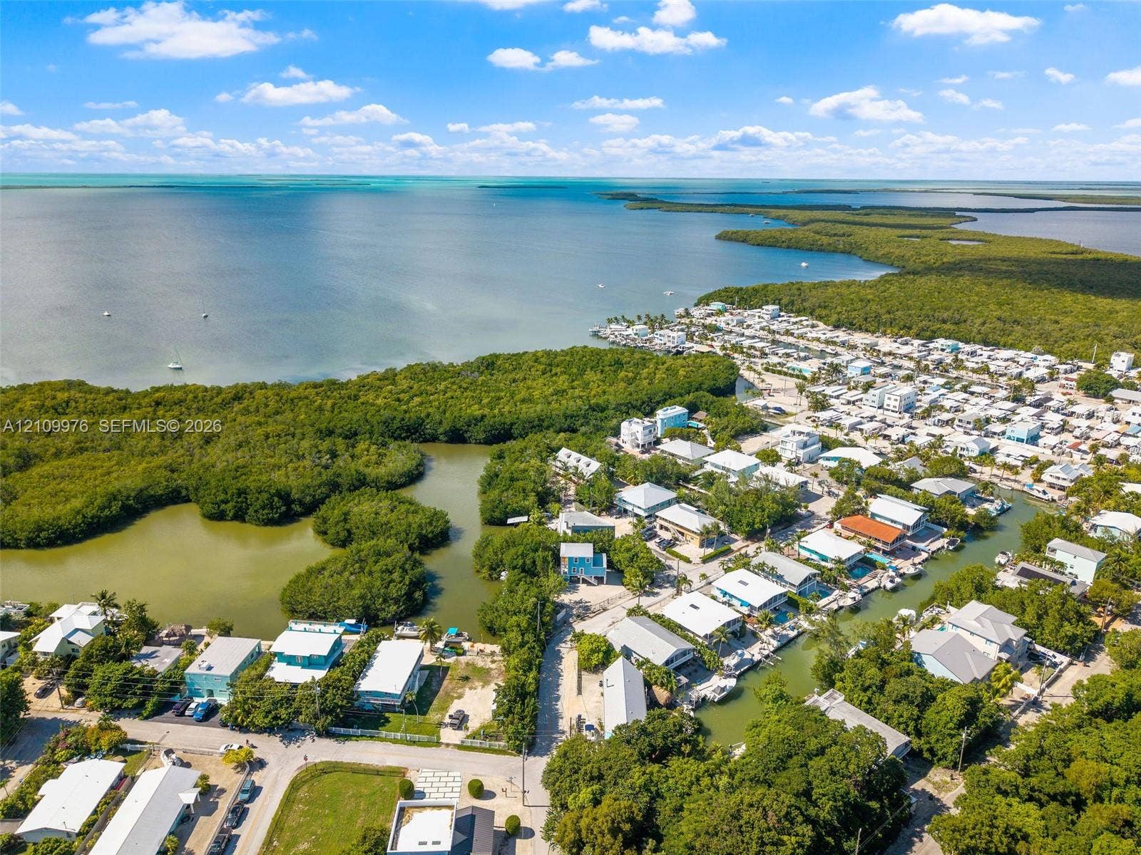 43 Waterways Drive, Key Largo, FL 33037 Aerial perspective showcasing waterfront access, direct proximity to open coastal waters, and extensive native mangrove vegetation