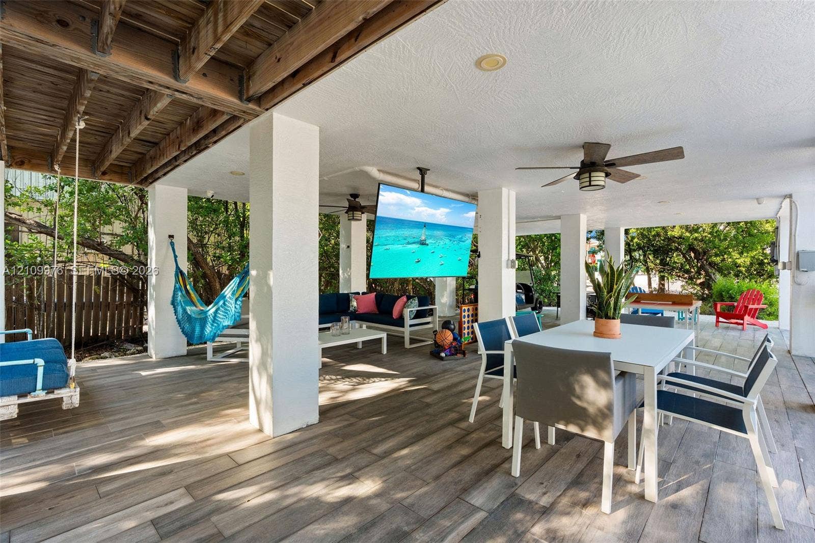 43 Waterways Drive, Key Largo, FL 33037 Covered patio featuring wood-finish flooring, recessed lighting, ceiling fans, and a ceiling-mounted television