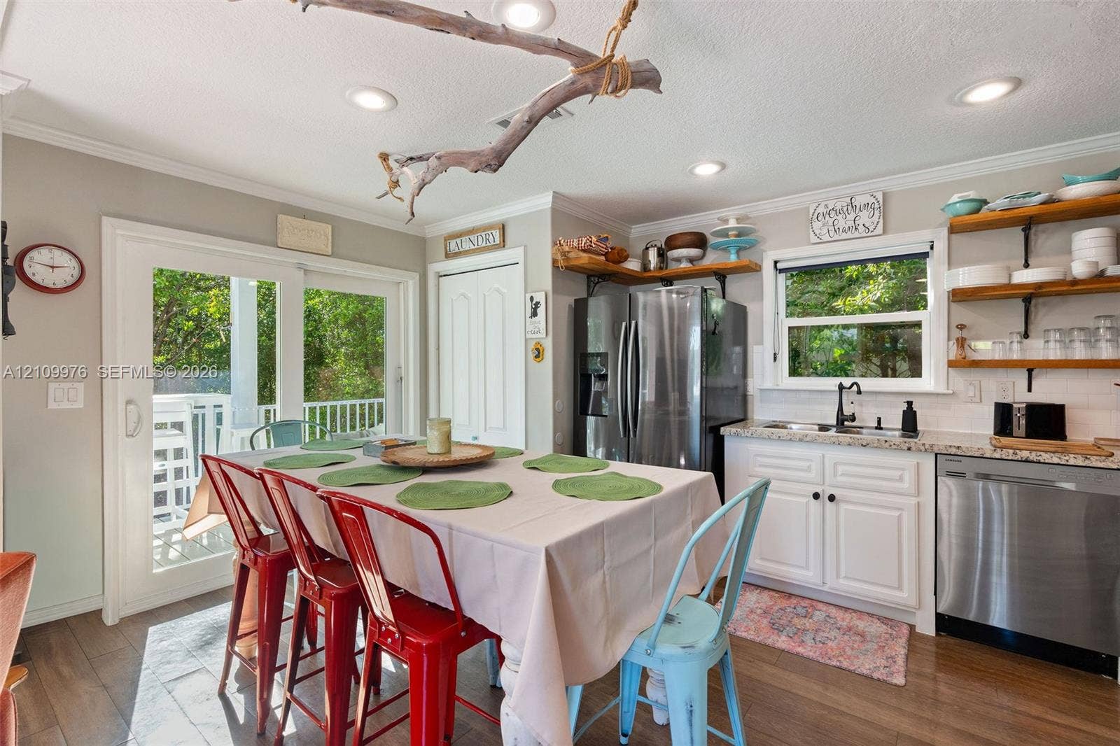43 Waterways Drive, Key Largo, FL 33037 Kitchen featuring white cabinetry, stone-finish countertops, stainless steel appliances, wood-finish flooring, and sliding glass doors