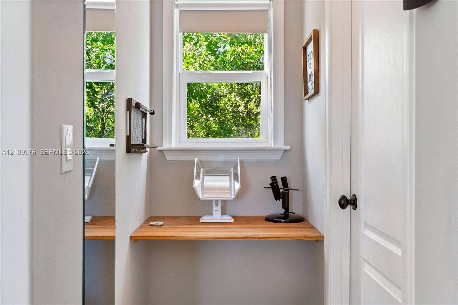 43 Waterways Drive, Key Largo, FL 33037 Built-in wooden wall-mounted desk, dual-pane window with white trim, and interior panel door with black hardware