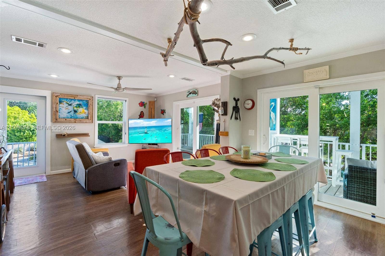 43 Waterways Drive, Key Largo, FL 33037 Open-concept floor plan featuring wood-finish flooring, recessed lighting, ceiling fan, and sliding glass doors opening to an exterior deck